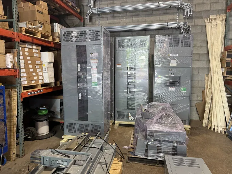 Panelboard and crated electrical parts in a warehouse — Appleton, WI