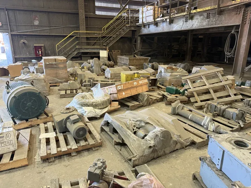Crated motors and equipment staged on a plant floor