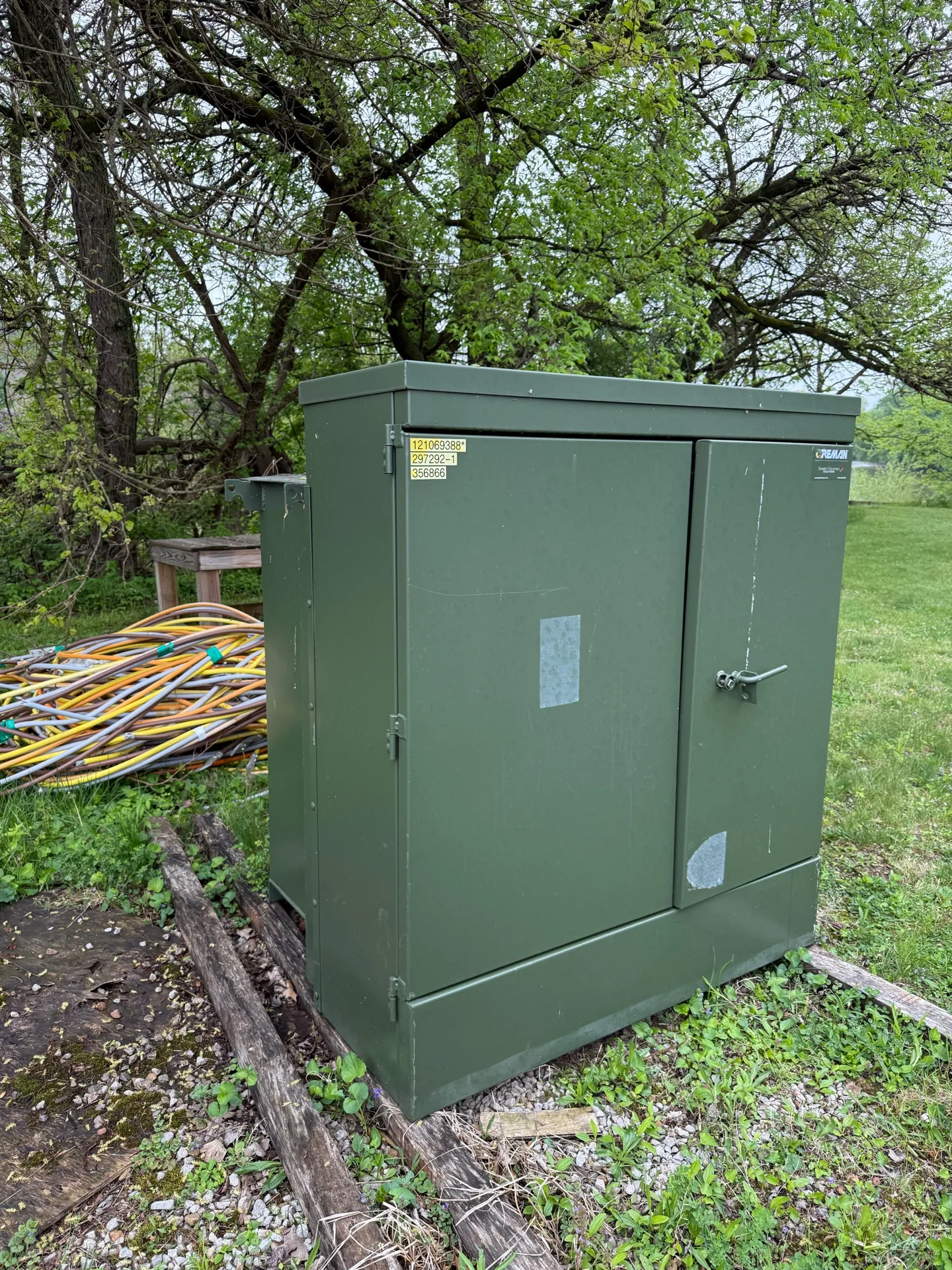 Green pad-mount transformer set on a concrete pad — Rolla, MO